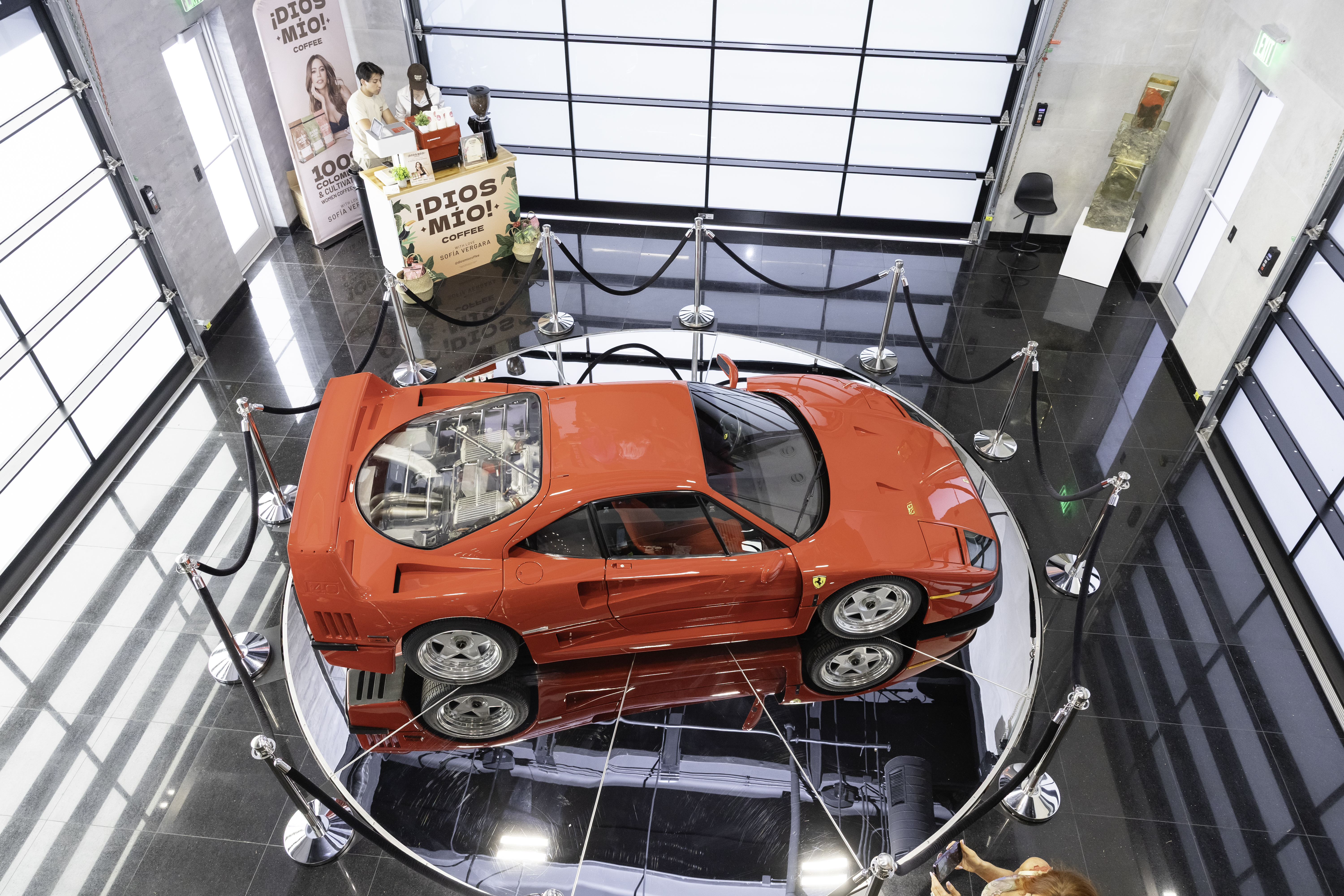 Aerial view of a classic Ferrari on display inside The Club House at CollectionSuites